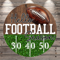 A wooden sign with a football and the text "Hello Football Season" displayed on it.