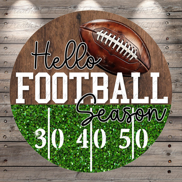 A wooden sign with a football and the text "Hello Football Season" displayed on it.