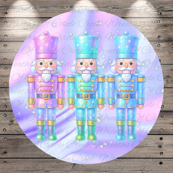 A circular illustration featuring three nutcracker characters in a festive holiday scene, with a purple and pink background and sparkling stars.