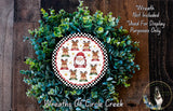 A wreath made of green leaves and featuring a Santa Claus image, with the text "Wreath Not Included * Used For Display Purposes Only" and "Wreaths Of Circle Creek" below it.