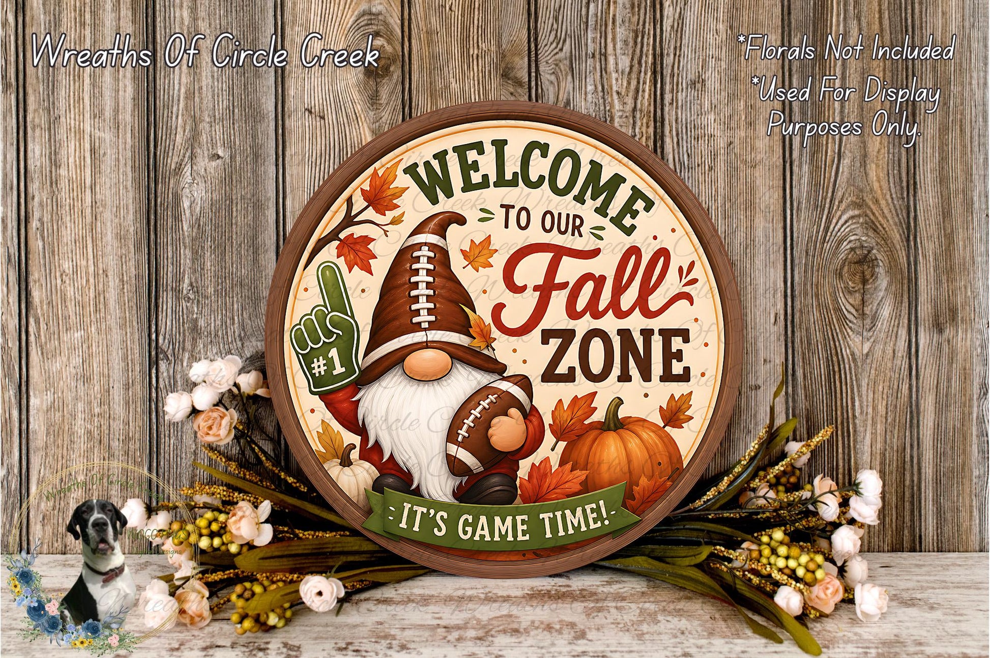 A round sign with a gnome holding a football and surrounded by autumn leaves, flowers, and a pumpkin, with the text "Welcome to our Fall Zone" and "It's Game Time!"