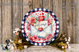 a decorative round sign with a floral design, surrounded by a bouquet of flowers and a wooden background.