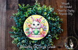 a wreath with a bunny and flowers, surrounded by greenery, and a sign that reads &quot;Happy Easter&quot;.