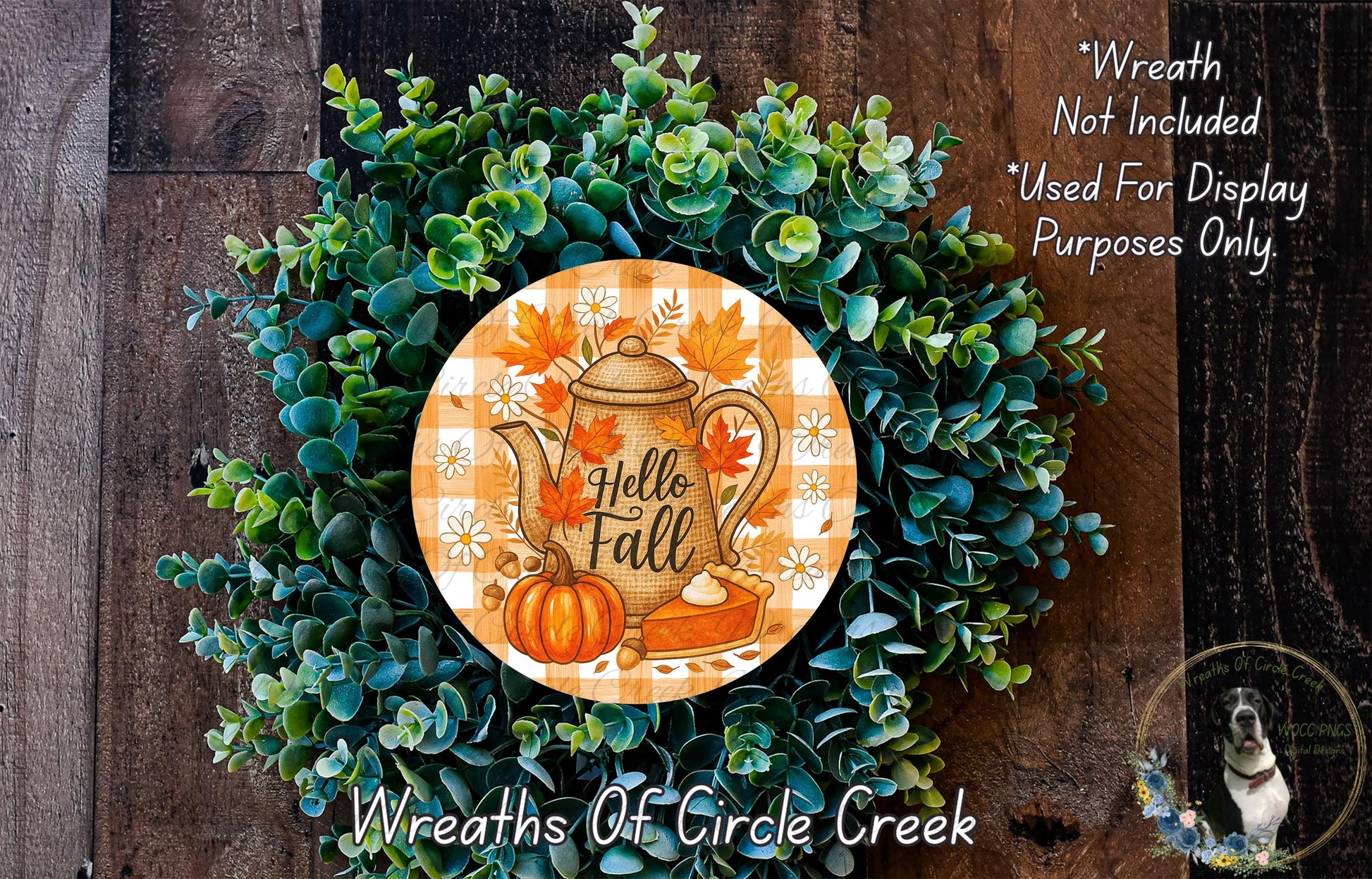A wreath made of green leaves and a pumpkin, with a teapot and fall-themed decorations, including a "Hello Fall" sign.
