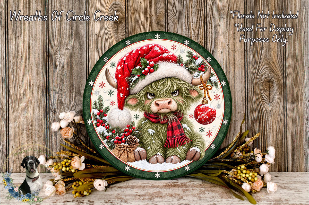 A decorative plate featuring a cartoon cow wearing a Santa hat and scarf, surrounded by Christmas-themed elements such as berries, flowers, and a wreath.