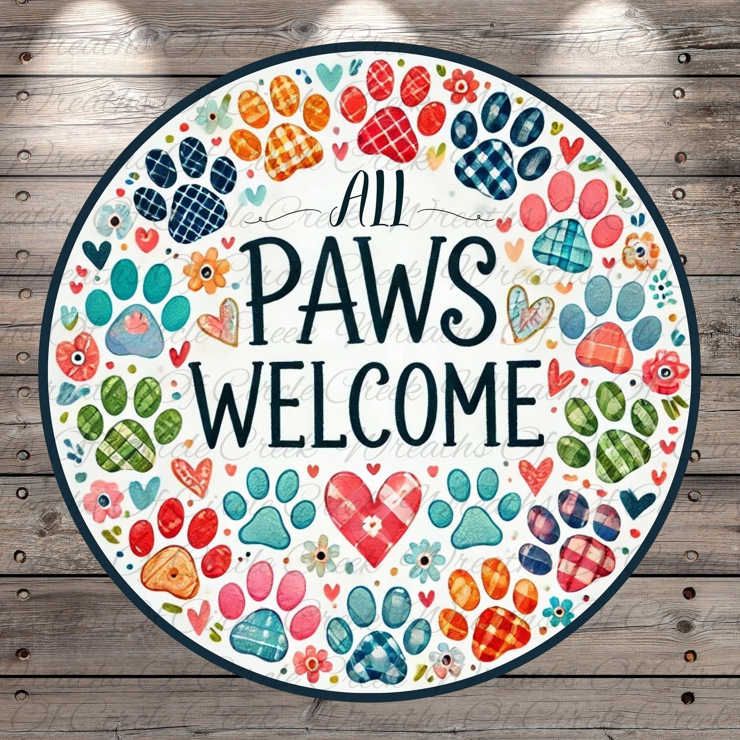 The image is a circular sign with a wooden background, featuring a variety of colorful paw prints and hearts surrounding the text "All Paws Welcome".