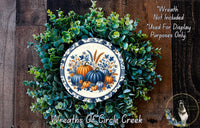 a wreath with a picture of pumpkins on it