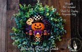 A Halloween-themed wreath made of green foliage and featuring a jack-o-lantern character.