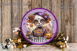 a decorative plate with a skeleton wearing a purple hat and holding a bowl of candy, surrounded by Halloween-themed elements such as flowers, pumpkins, and bats. The plate is placed on a wooden surface, and there is a small dog in the background.