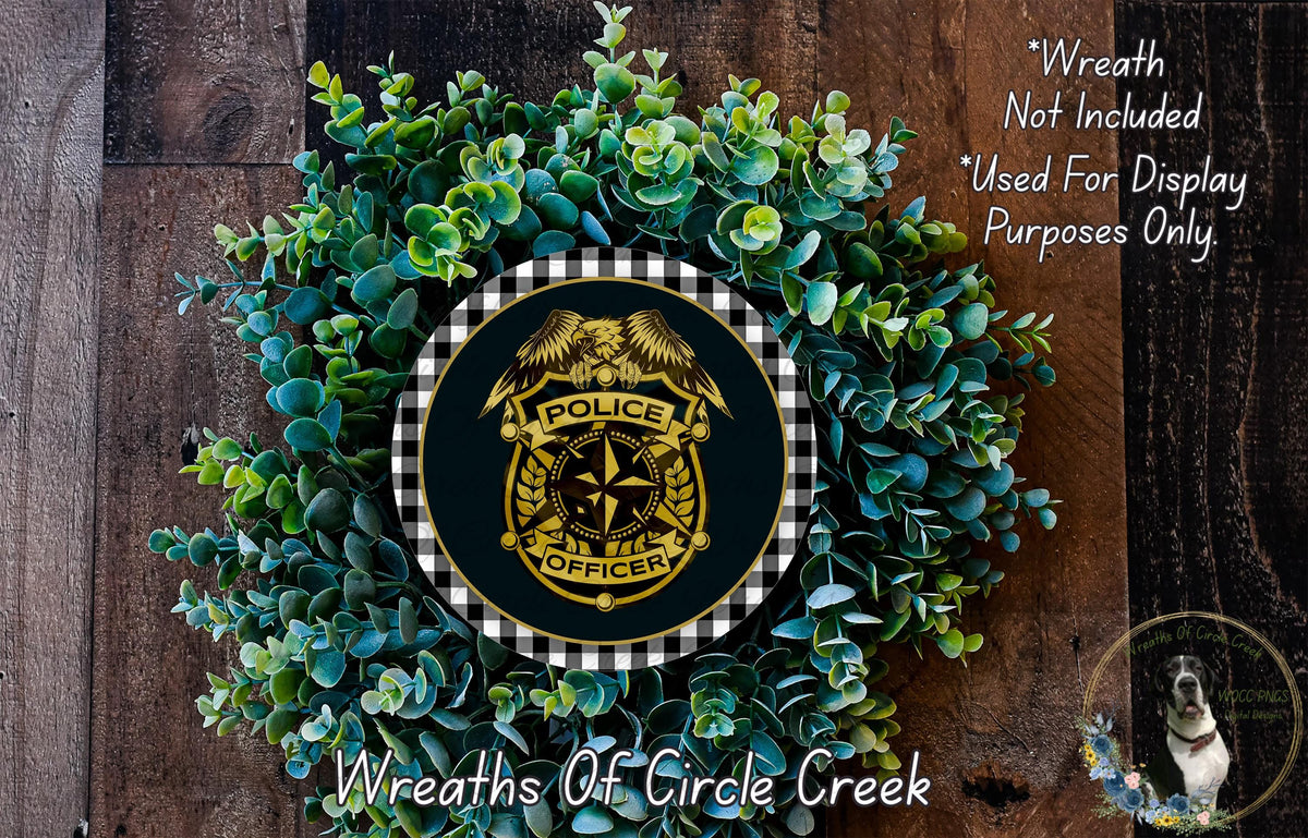 A wreath made of green leaves and a police officer badge, with the text "Wreath Not Included * Used For Display Purposes Only" and "Wreaths Of Circle Creek" below it.
