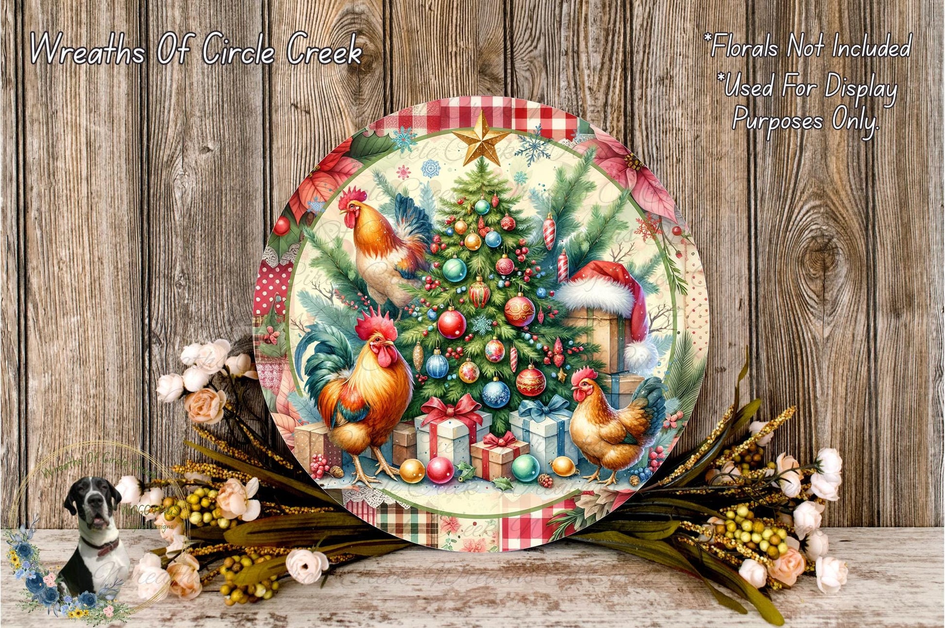 A decorative Christmas wreath with a colorful, festive design featuring a Christmas tree, roosters, and presents. The wreath is displayed on a wooden surface, surrounded by flowers and greenery.