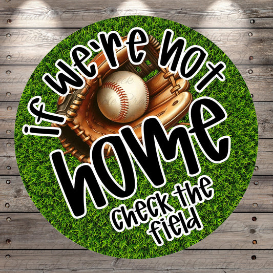 A baseball glove and ball are displayed on a grassy surface, with the text "If we're not at home, check the field" written around them.