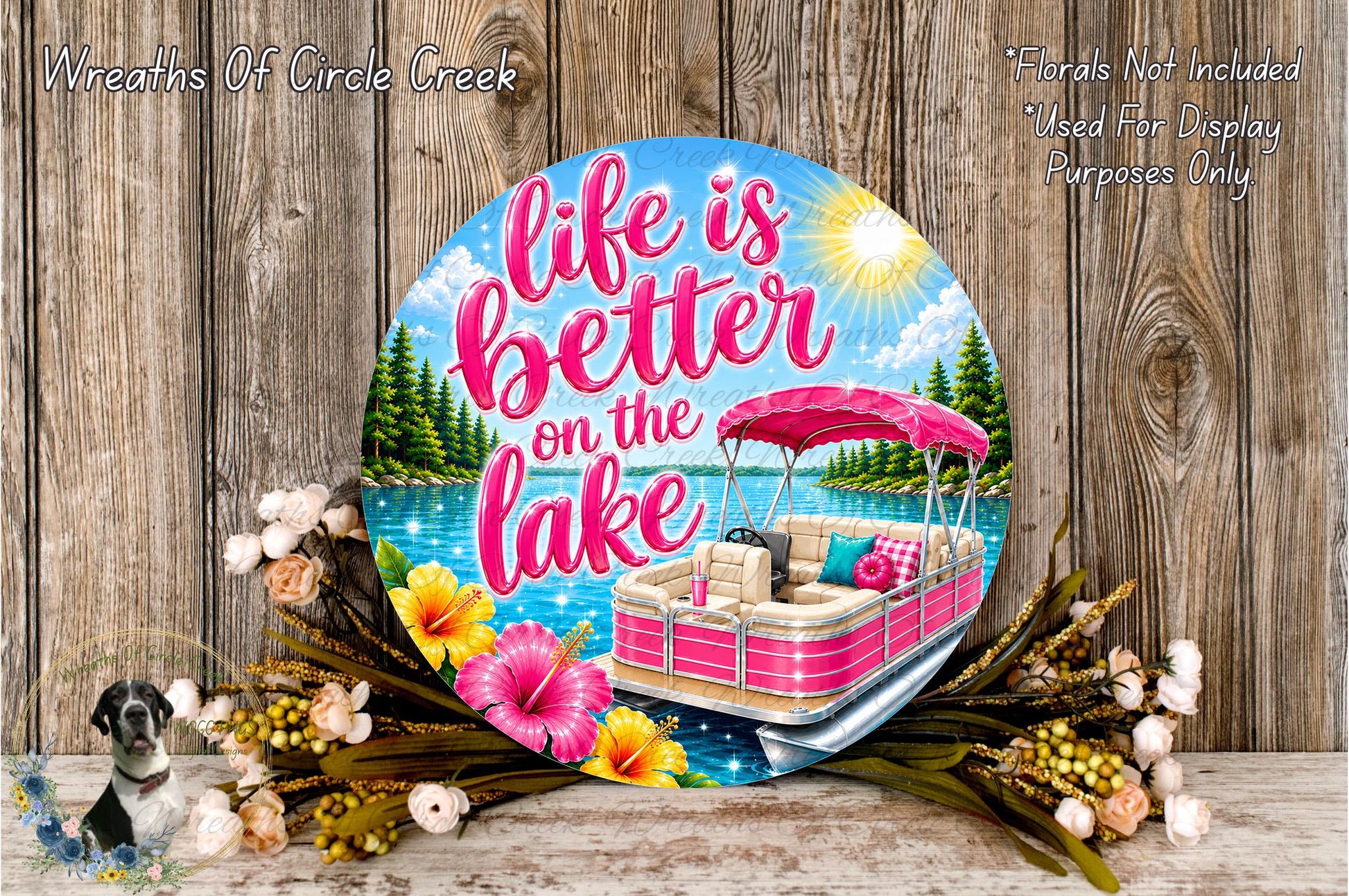 A decorative sign with the text "Life is better on the lake" and an illustration of a boat on a lake surrounded by flowers and a sunny sky.