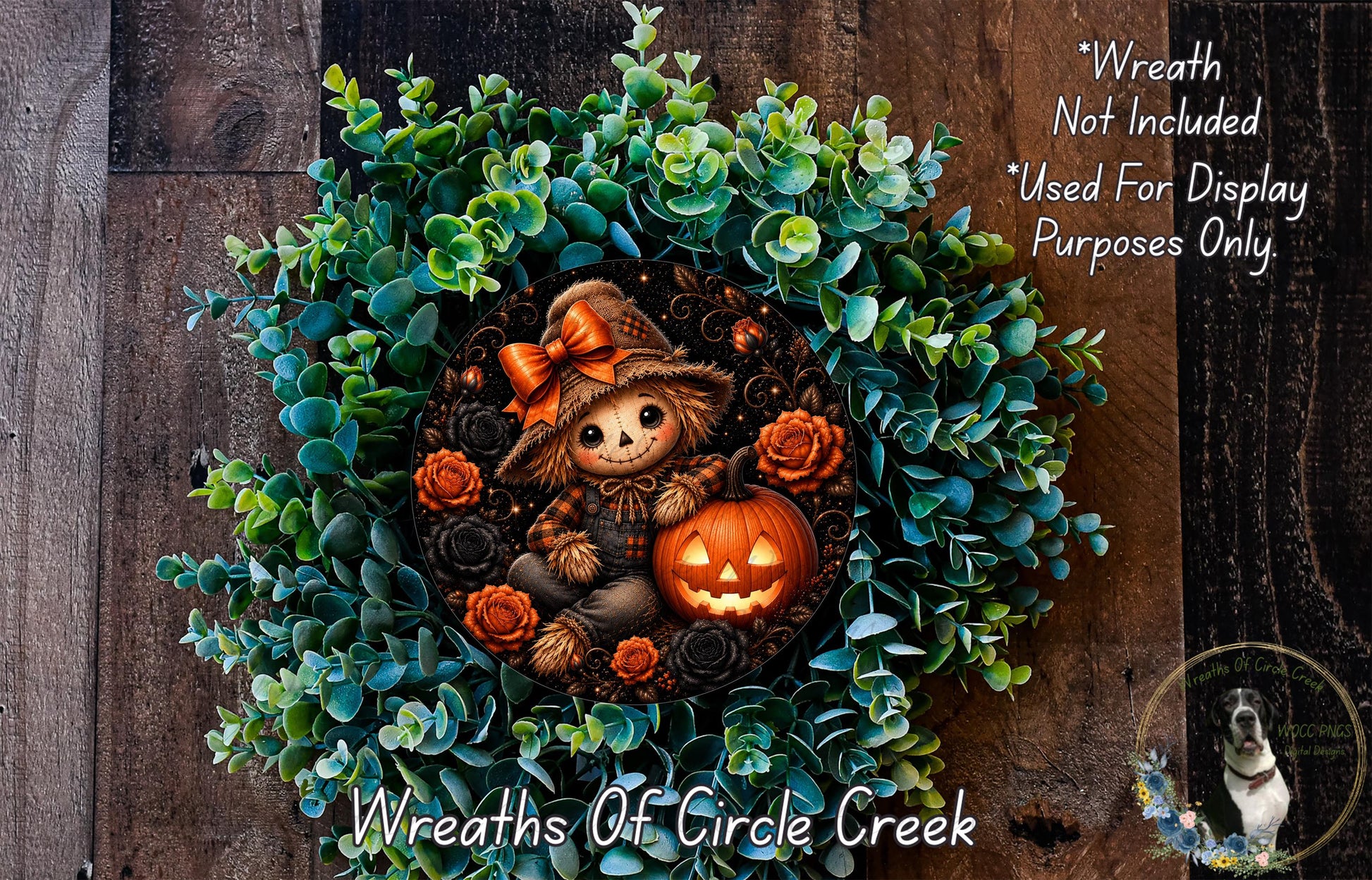 a Halloween-themed wreath with a scarecrow figure, a carved pumpkin, and various greenery. The wreath is displayed on a wooden surface, and there is a small dog in the background.