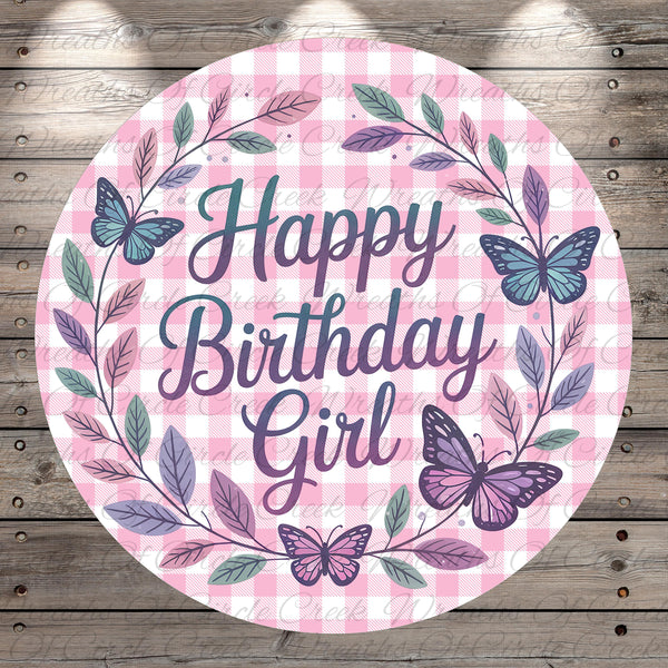 A round, pink and white plaid banner with the text "Happy Birthday Girl" surrounded by butterflies and leaves.