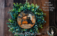 a wreath with a picture of a witch on it