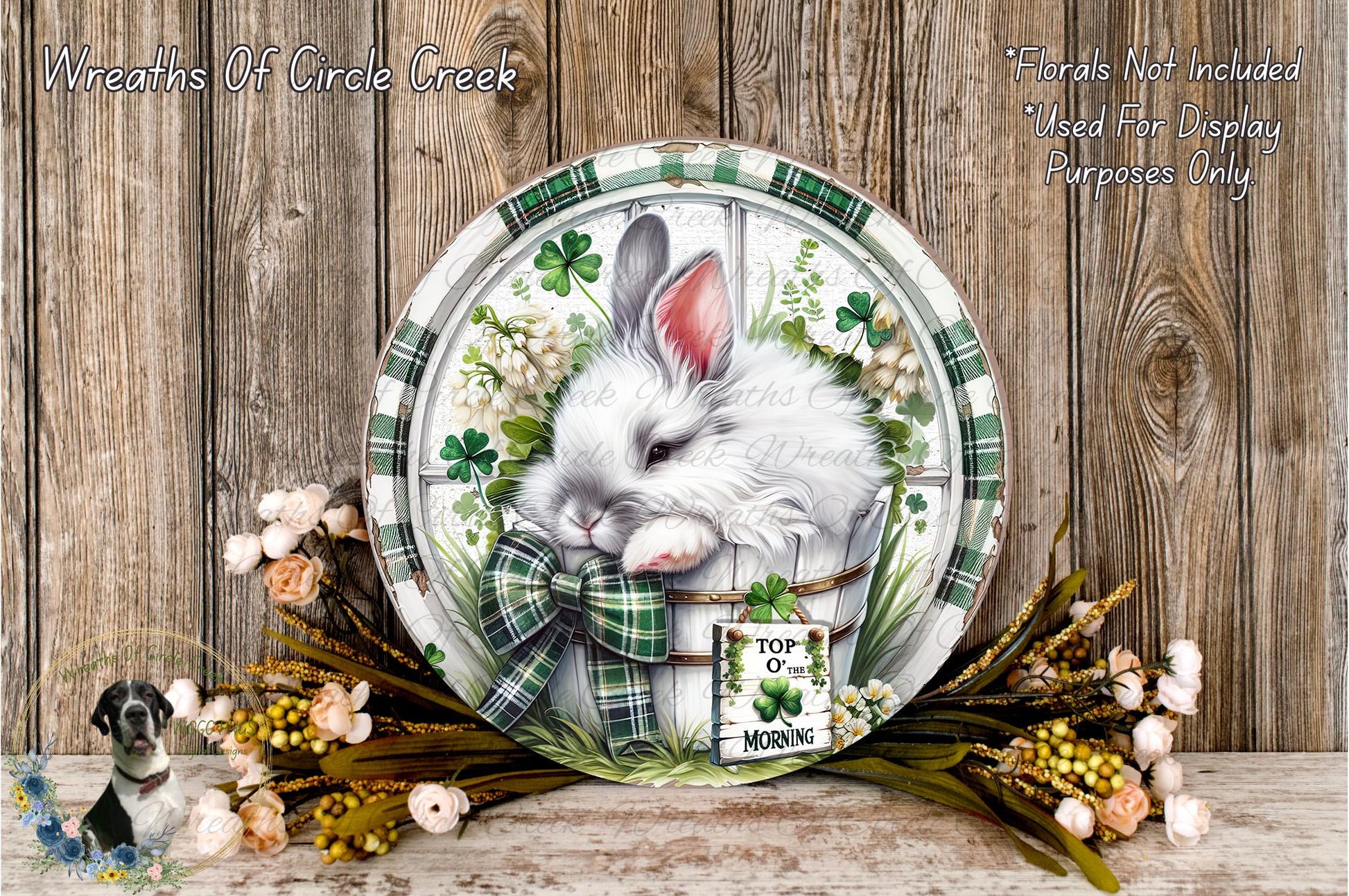A decorative plate featuring a white rabbit surrounded by a floral arrangement and a sign that reads "Top of the Morning".