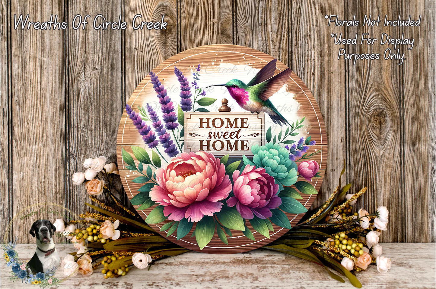 a wooden sign with a colorful bird perched on it, surrounded by a variety of flowers and greenery. The sign reads "HOME SWEET HOME" and is placed on a wooden surface.