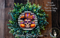 A wreath featuring a skull wearing a colorful hat, surrounded by pumpkins and greenery, with a text overlay that reads "Wreath Not Included * Used For Display Purposes Only" and "Wreaths Of Circle Creek".