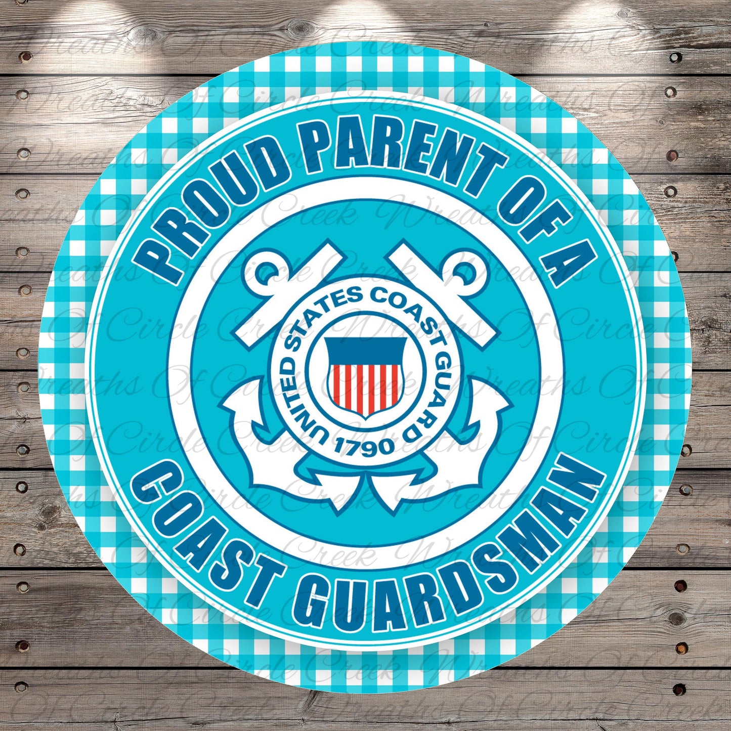 a circular sign with a blue and white color scheme, displaying the text "Proud Parent of a Coast Guarderman" and the United States Coast Guard seal.