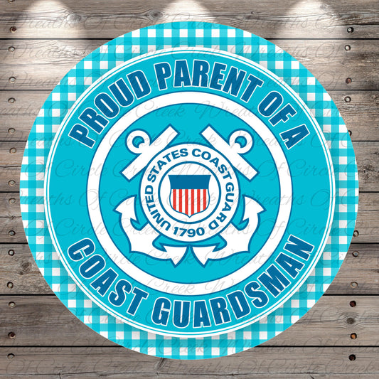 a circular sign with a blue and white color scheme, displaying the text "Proud Parent of a Coast Guarderman" and the United States Coast Guard seal.