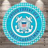 a circular sign with a blue and white color scheme, displaying the text "Proud Parent of a Coast Guarderman" and the United States Coast Guard seal.