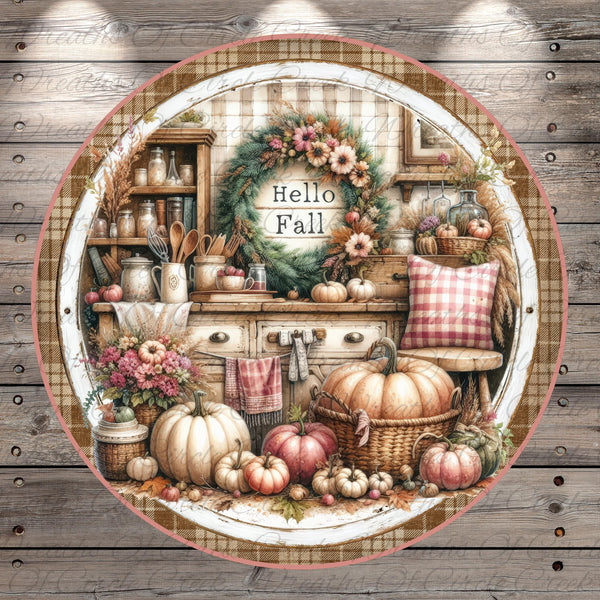 A round, decorative plate with a wreath and various fall-themed items arranged on a wooden surface.