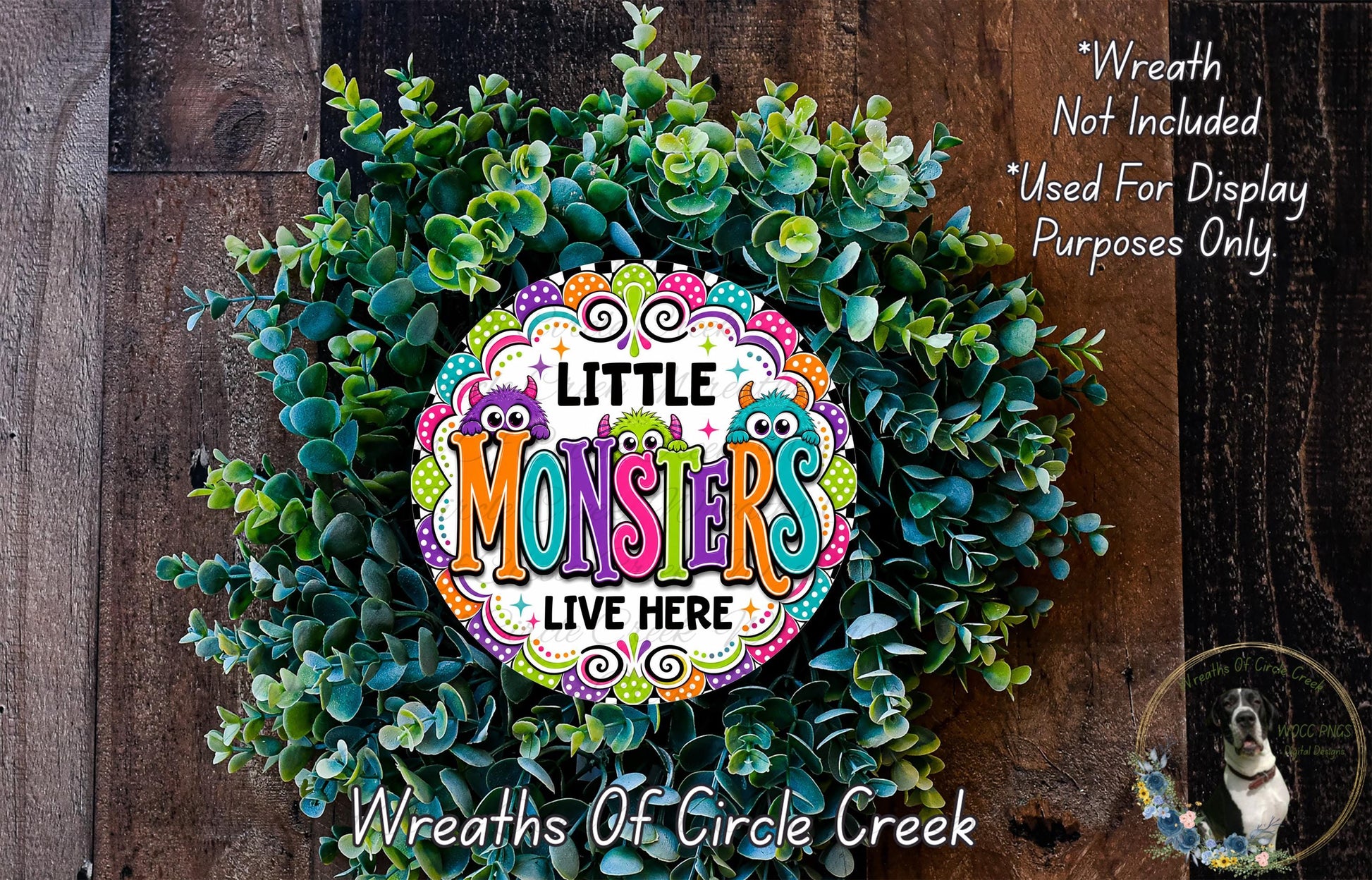 a colorful wreath made of green leaves and flowers, with the text "Little Monsters LIVE HERE" displayed prominently in the center.