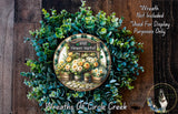 a wreath made of various green and yellow flowers, including roses and other foliage, displayed on a wooden surface. The wreath is labeled as an &quot;Irish Flower Market&quot; and is described as a &quot;Wreath of Circle Creek&quot;.