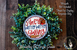 A wreath made of green leaves and a baseball-themed sign, with the text "They're better batter swing" displayed on it.