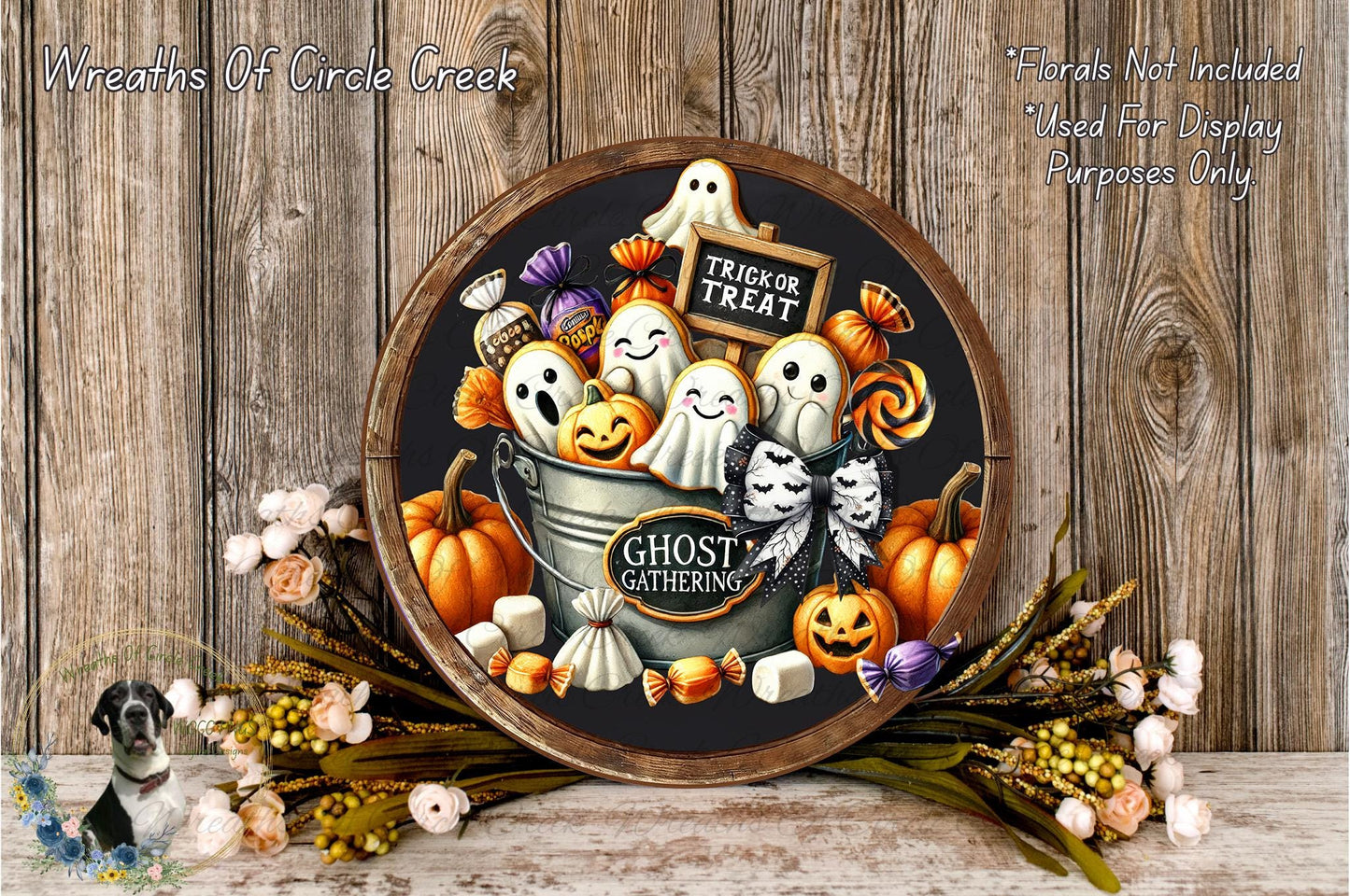 a Halloween-themed wreath with various spooky and festive elements, including ghostly figures, pumpkins, and candy. The wreath is displayed on a wooden surface, surrounded by a floral arrangement and a sign that reads "Trick or Treat".