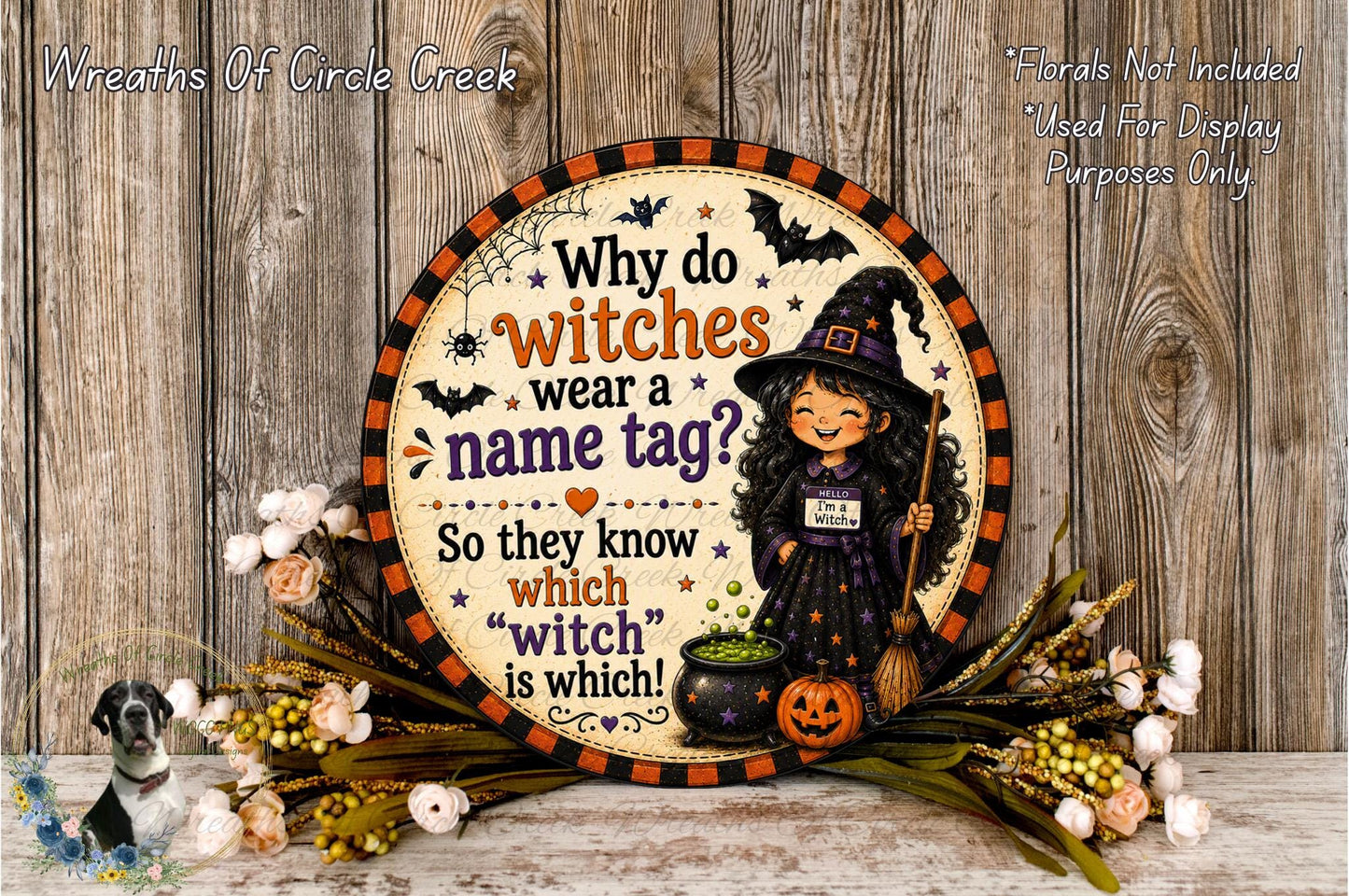 A Halloween-themed sign with a witch and a pumpkin, surrounded by flowers and a wooden background.