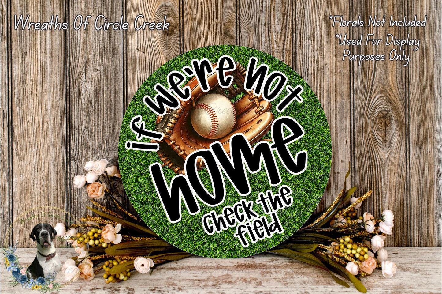 a round sign with the text "If we're not home, check the field" on it, surrounded by a baseball glove and ball, and a floral arrangement.