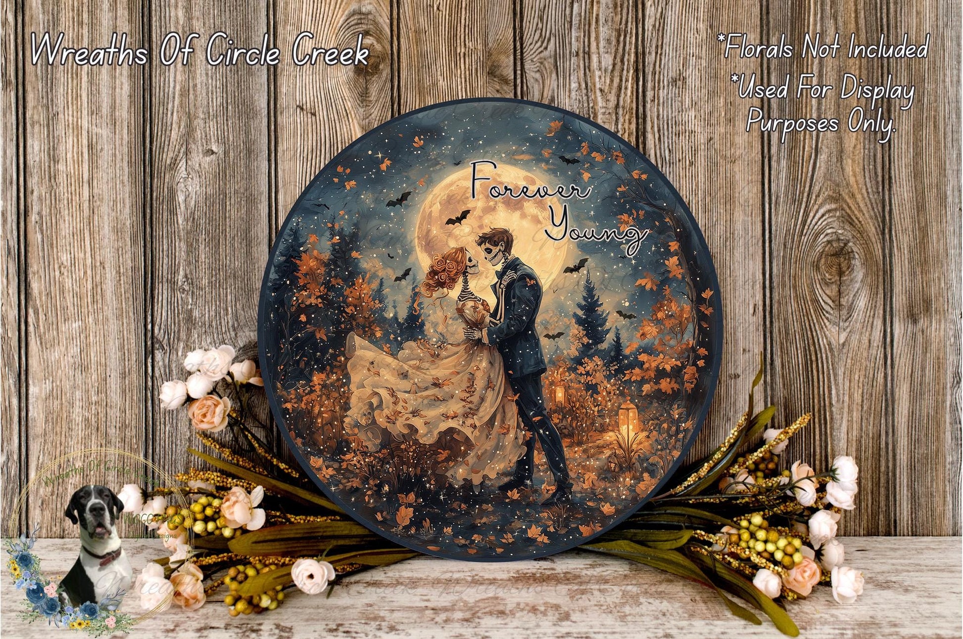 a decorative plate with a painting of a couple embracing under a full moon, surrounded by autumn foliage and flowers.