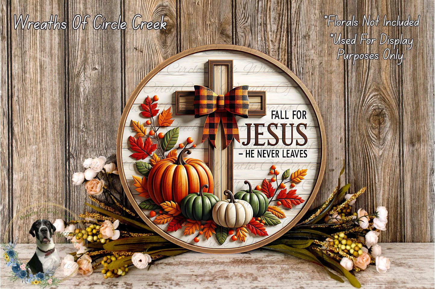 a decorative wreath with a cross and fall-themed elements, including pumpkins, leaves, and flowers, set against a wooden background.