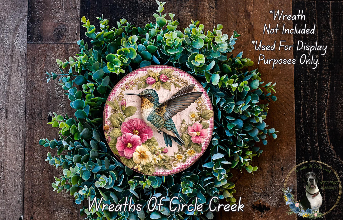 A wreath made of green foliage and pink flowers, with a bird in flight depicted on the wreath.