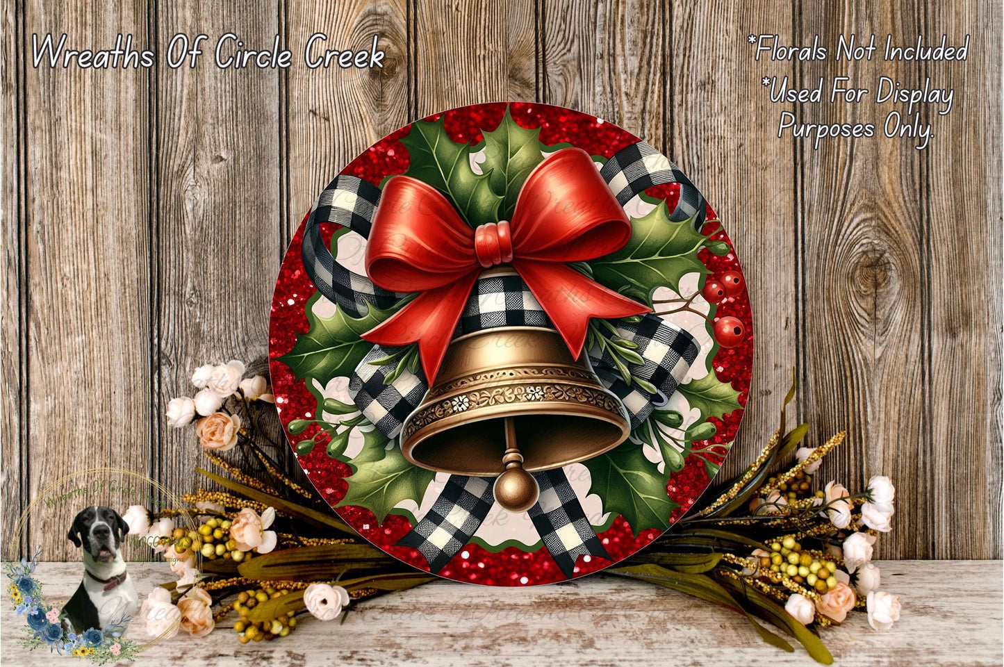 A festive wreath with a red bow, a bell, and a floral arrangement is displayed on a wooden surface.