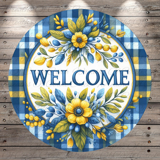 A circular welcome sign with a blue and yellow floral design, featuring the word "WELCOME" prominently displayed in the center.