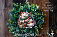 A wreath made of green leaves and a white bear wearing a red and green scarf, with a text overlay that reads "Wreath Not Included * Used For Display Purposes Only" and "Wreaths of Circle Creek".