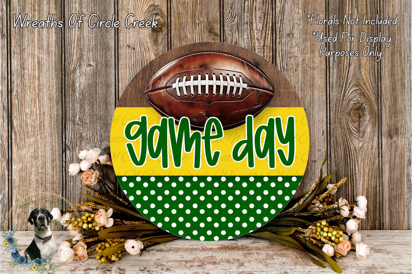 A wooden sign with a football on it, surrounded by a wreath of flowers and greenery, with the text "game day" displayed on the sign.