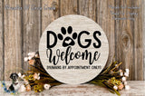 a wooden sign with the text "Dogs Welcome" and a paw print, surrounded by a floral arrangement and a wooden wall.