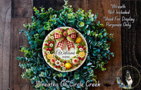 a wreath with a welcome sign on it