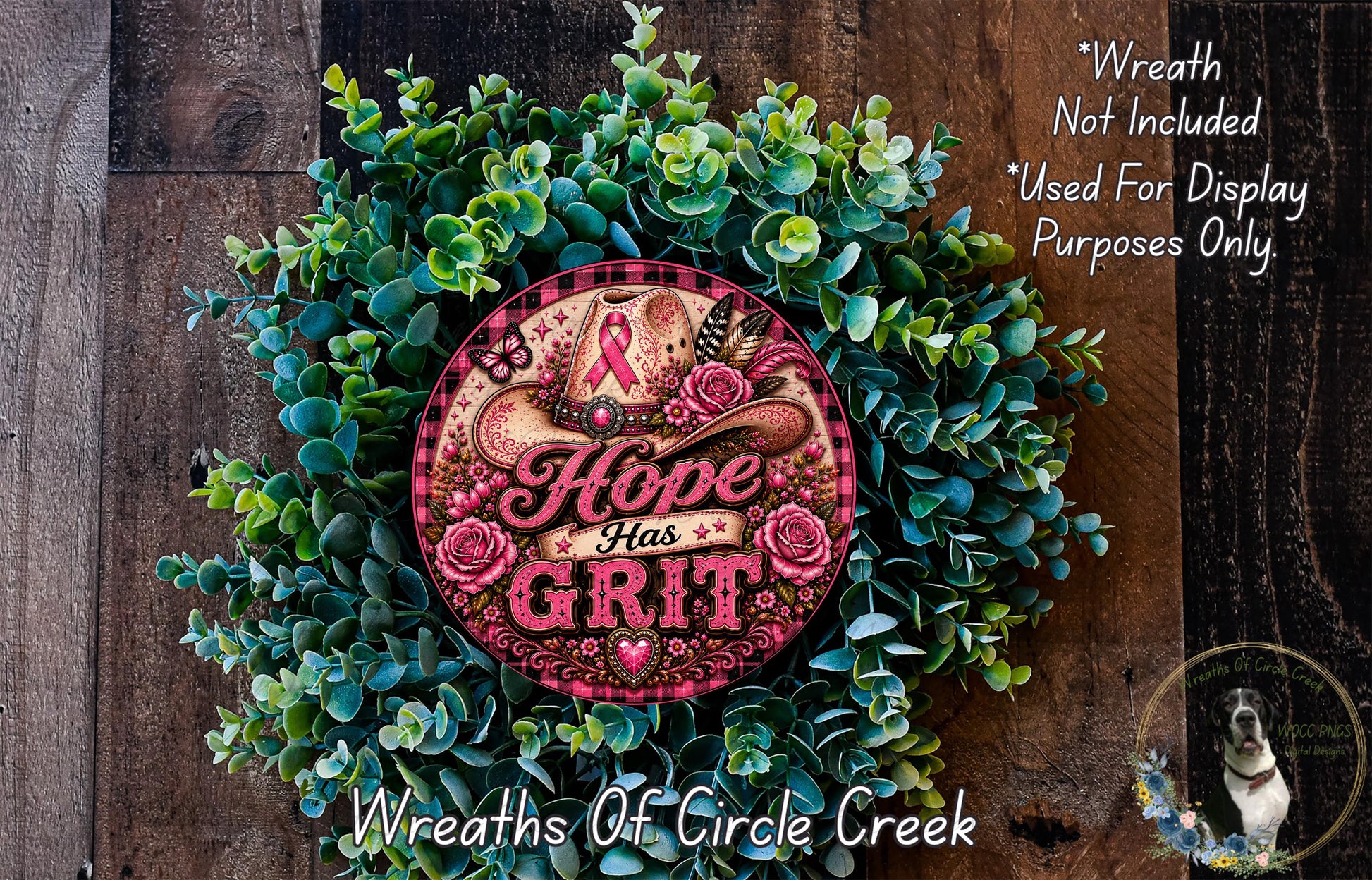 a wreath made of green leaves and flowers, with a pink and gold circular sign that reads "Hope Has Grit". The sign is surrounded by the wreath, and there is a small dog in the bottom right corner of the image.