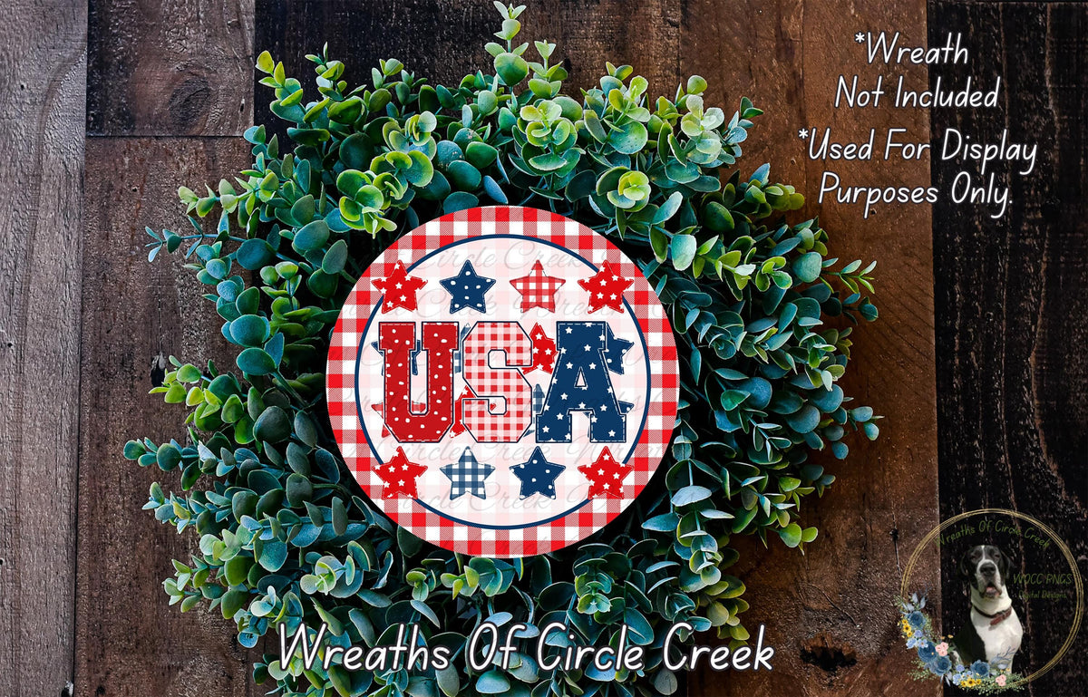 A wreath made of green leaves and featuring a red and white circular sign with the text "USA" in the center.