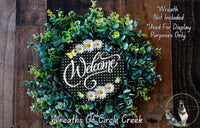 a welcome wreath with daisies and daisies on it