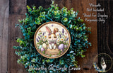 a wreath with a bunny and flowers, including Easter eggs, hanging on a wooden wall.
