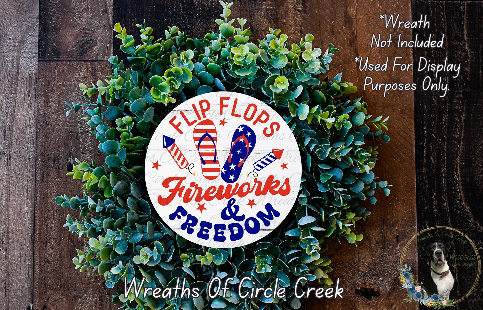 A wreath made of green leaves and featuring a white circular sign with the text "FLIP FLOPS FIREWORKS & FREEDOM" and an American flag design.