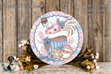 a decorative plate with a whimsical design, including a cupcake, snowman, and other festive elements, placed on a wooden surface.