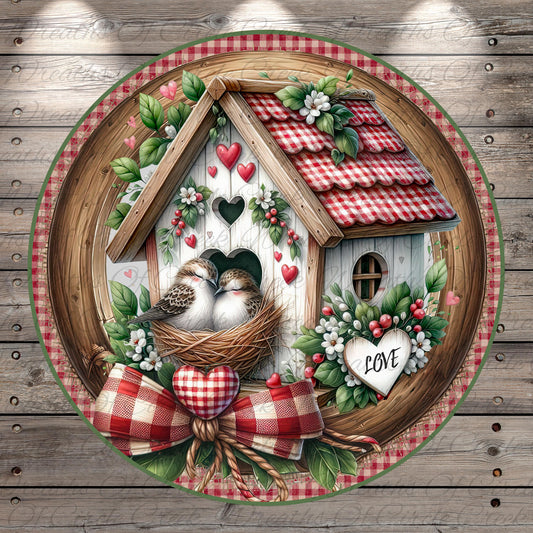 A decorative birdhouse with a red and white checkered roof, surrounded by flowers and greenery, with two birds sitting in the nest. The word "LOVE" is displayed on a heart-shaped ornament.