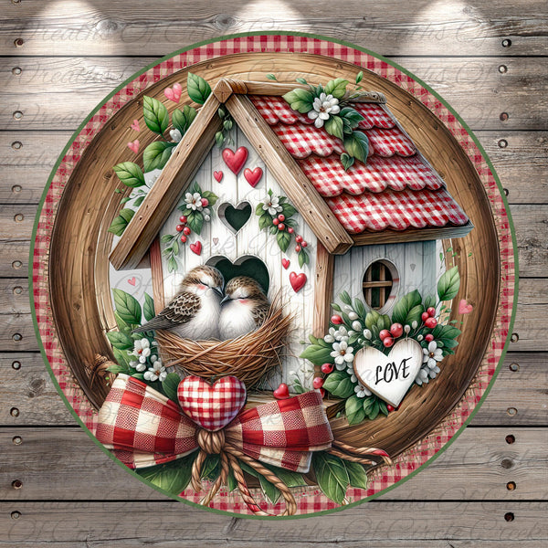 A decorative birdhouse with a red and white checkered roof, surrounded by flowers and greenery, with two birds sitting in the nest. The word "LOVE" is displayed on a heart-shaped ornament.